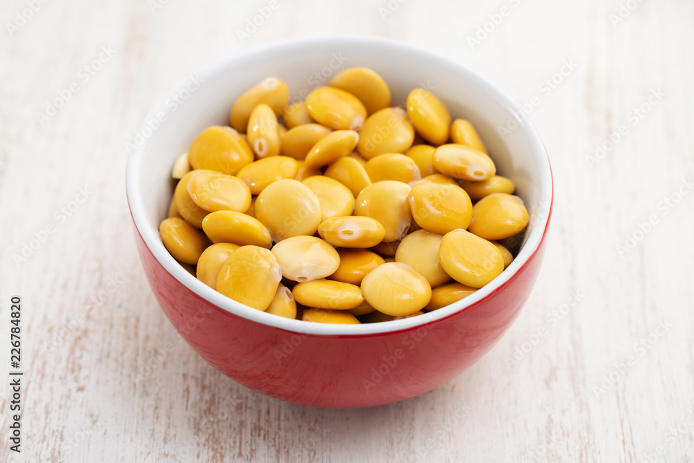 salted lupins in red bowl salted lupins in red bowl