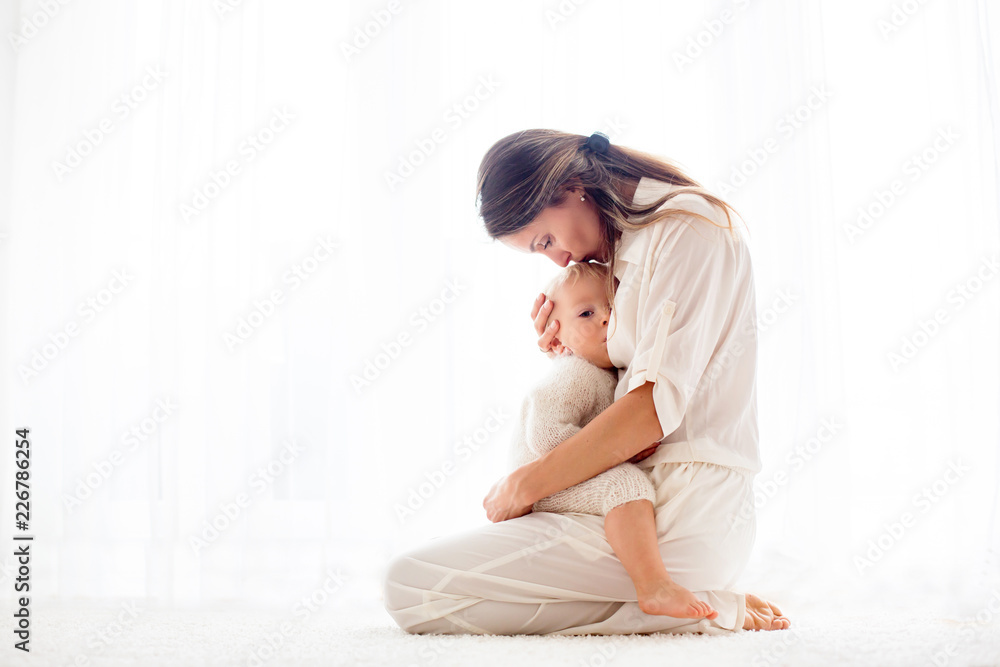 Young mother breastfeeding her toddler baby boy . Young mother breastfeeding her toddler baby boy .