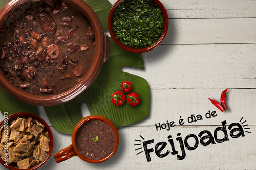 Brazilian Feijoada Food. Written "Today is Feijoada's Day" in Portuguese. Top view with copy space.