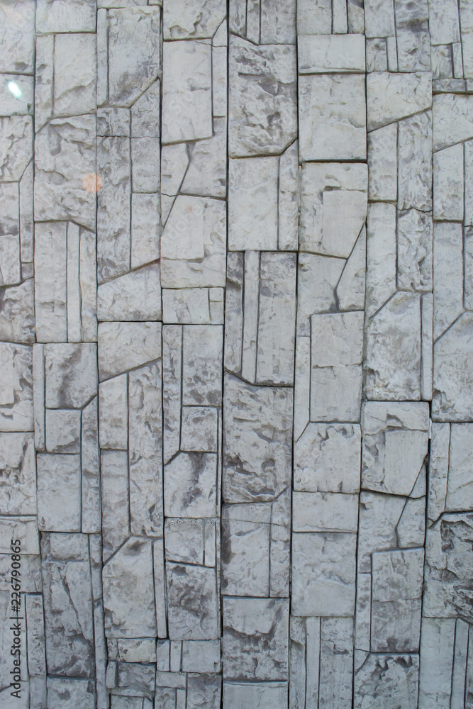Obraz premium textured gray stone patterned tile laid out on a wall in the open air