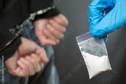 close up of addict narcotics dose cocaine. drug addict was arrested, police officer finds drugs during the search