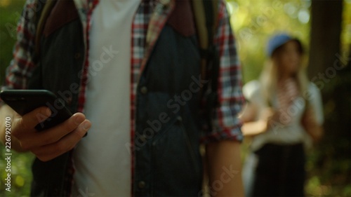 Close up phone in the hands of traveler during hiking adventure