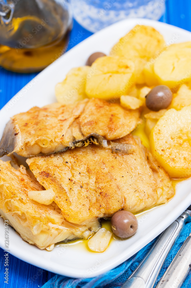 cod fish with fried potato on white dish