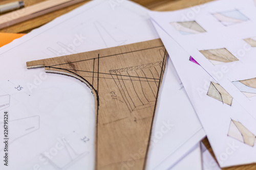 Eco friendly woodworker's shop. sketches and plans on paper or wood, while making legs for a designer coffee table. Mastering woodery with peacefullness.