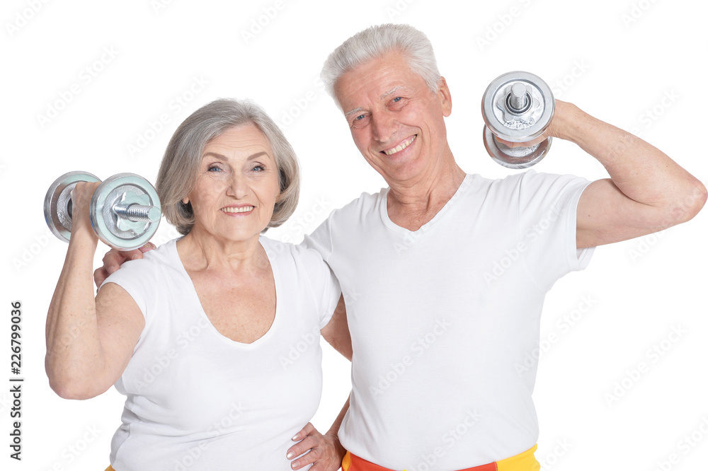 Portrait of smiling senior couple exercising isolated on white Portrait of smiling senior couple exercising isolated on white