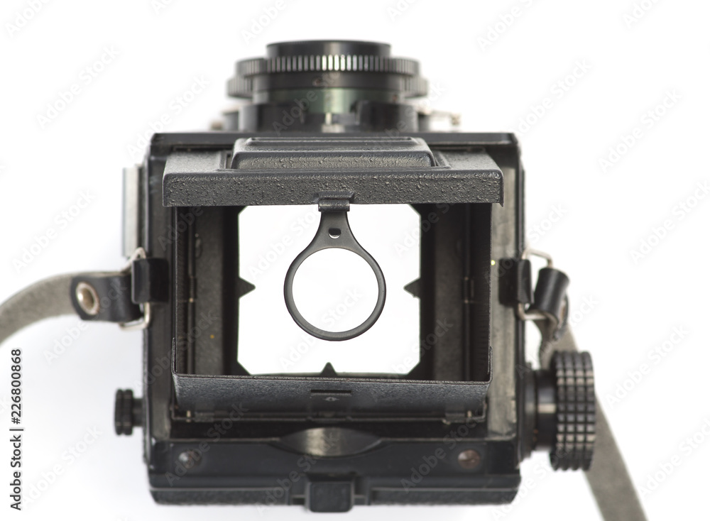 The viewfinder of an old, dual-lens reflex camera with a magnifying glass.