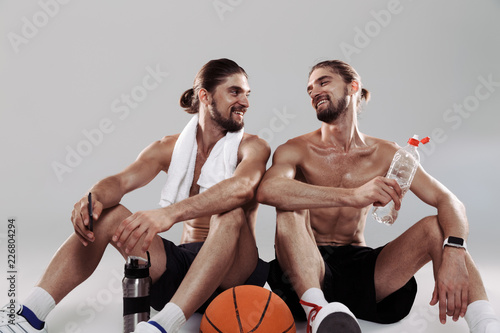 Portrait of a two happy muscular shirtless twin brothers photo