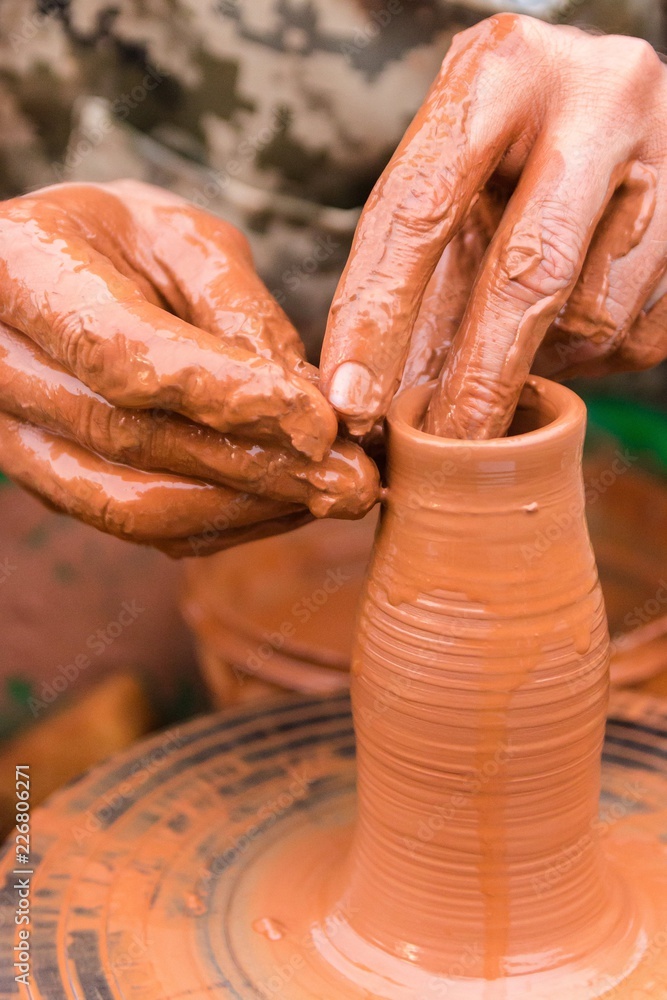 hands sculpt clay