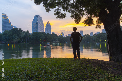 Tourist is visiting at Lumphini Park in Bangkok while sunset.