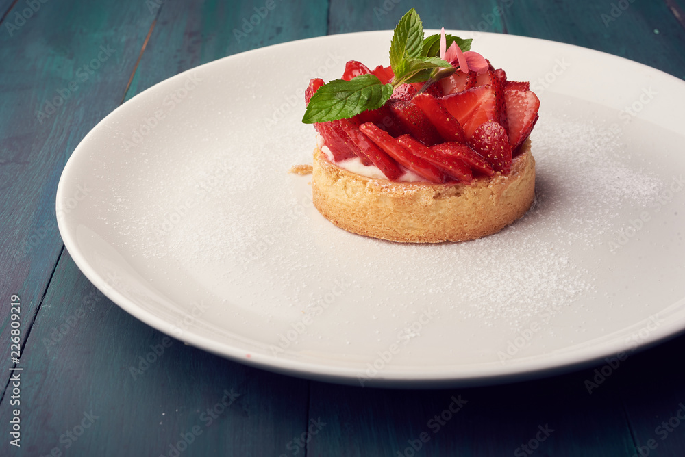Fresh baked homemade pie with strawberries and whipped cream and cinnamon on white plate. close-up. top or overhead view Fresh baked homemade pie with strawberries and whipped cream and cinnamon on white plate. close-up. top or overhead view
