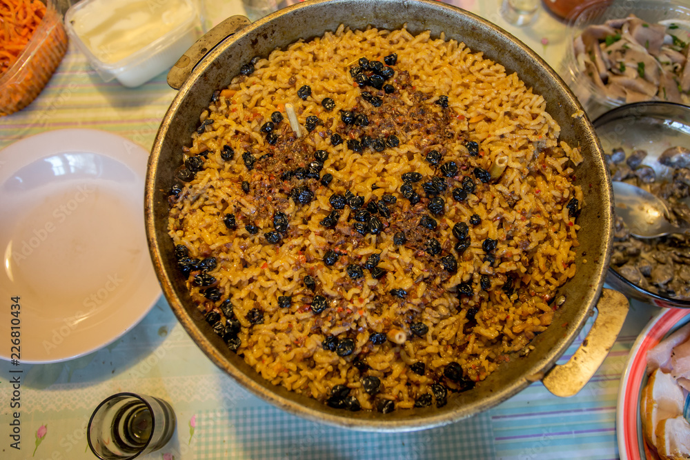 Pan with pilaf. The finished dish is put on the table. Pan with pilaf. The finished dish is put on the table.