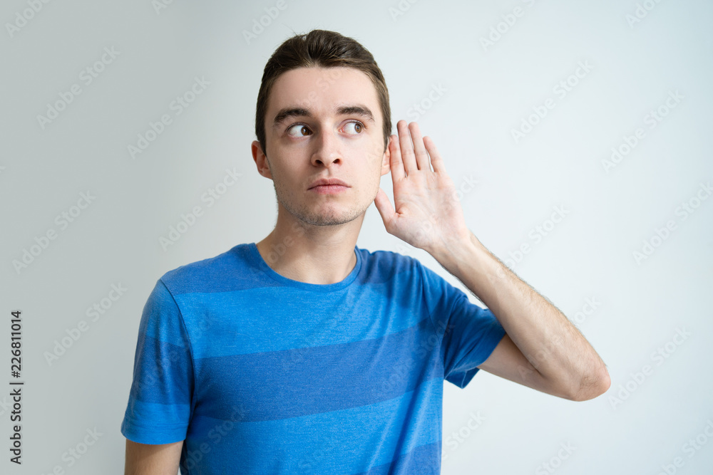 Curious Young Man Holding Hand Near Ear Attractive Guy Looking Away News Concept Isolated Front View On White Background Stock Photo Adobe Stock Curious Young Man Holding Hand Near Ear Attractive Guy Looking Away News Concept Isolated Front View On White Background Stock Photo Adobe Stock
