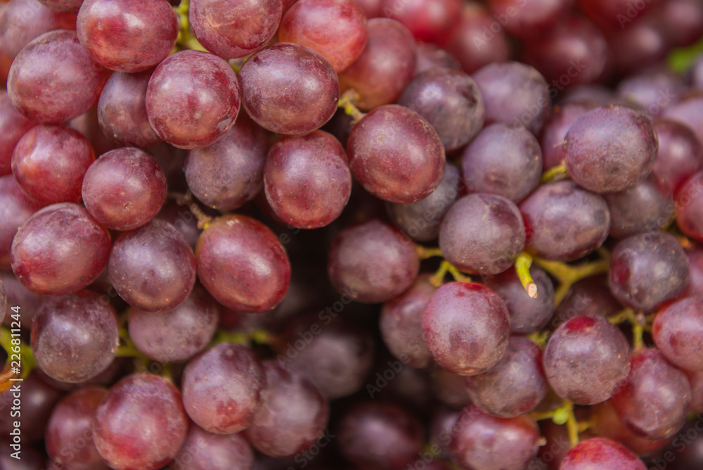 Healthy fruits red wine grapes background in the market.