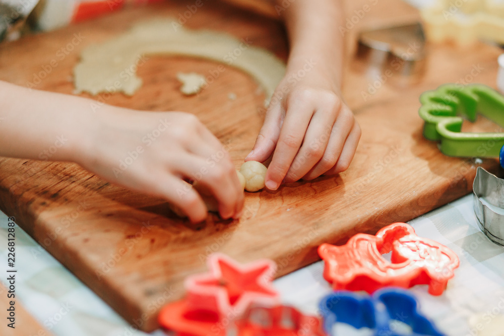 Child mixing flour in the kitchen, making dough Child mixing flour in the kitchen, making dough