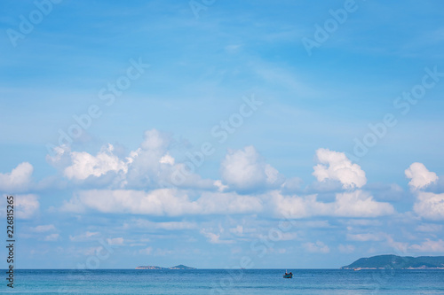 sea with blue sky and white clouds.