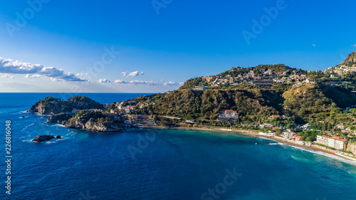 Aerial. View from beach toTaormina.  Taormina has been a tourist destination since the 19th century. Located on east coast of the island of Sicily, Italy. © mariusltu