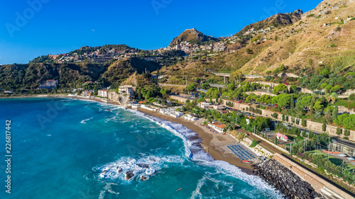 Aerial. View from beach toTaormina.  Taormina has been a tourist destination since the 19th century. Located on east coast of the island of Sicily, Italy. © mariusltu