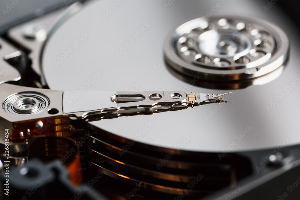 Disassembled hard drive from the computer, hdd with mirror effect. Opened hard drive from the computer hdd with mirror effects. Part of computer pc, laptop Disassembled hard drive from the computer, hdd with mirror effect. Opened hard drive from the computer hdd with mirror effects. Part of computer pc, laptop