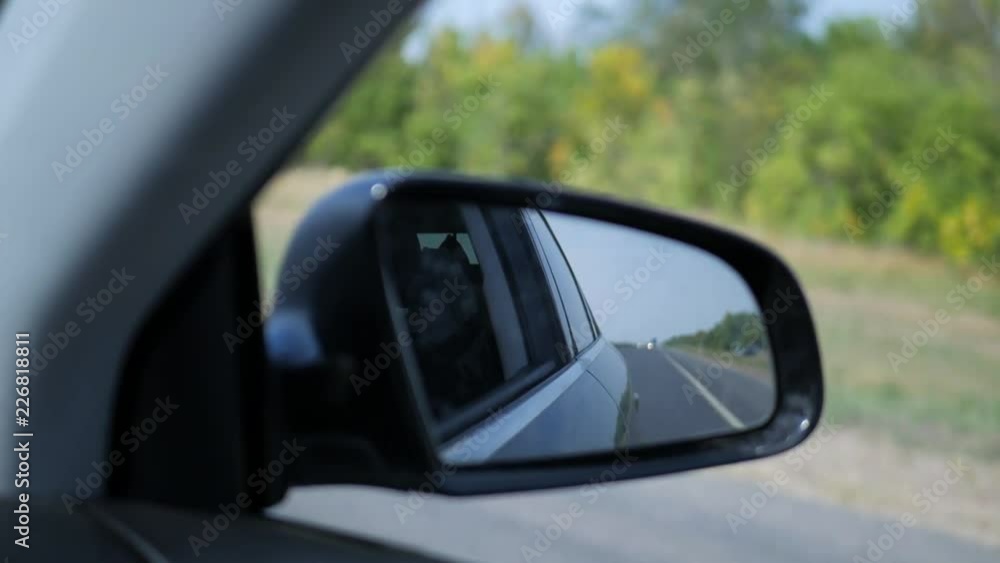 Landscape in the side view mirror of a car, on road countryside. Landscape in the side view mirror of a car, on road countryside.