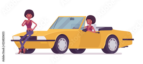 Young black woman near bright yellow cabriolet