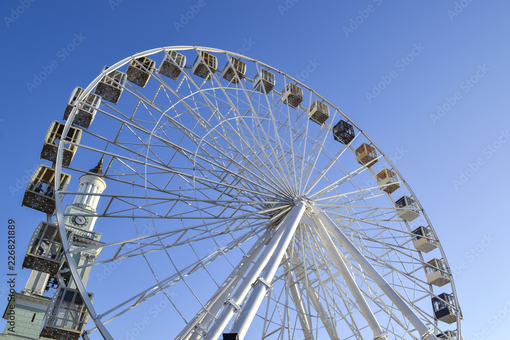 Ferris wheel against a blue sky background. Ferris wheel against a blue sky background.