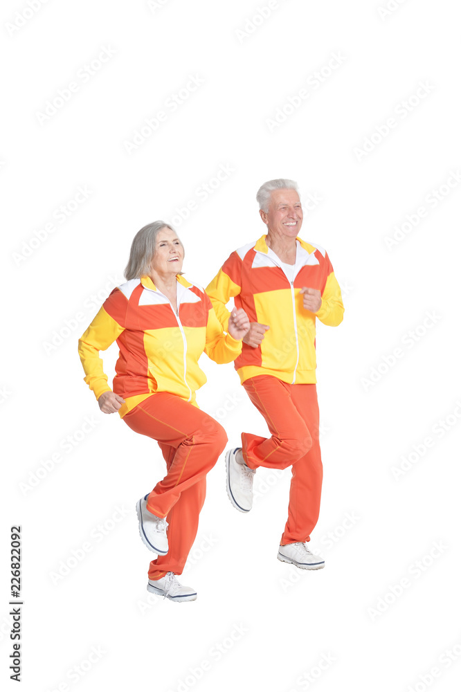 Portrait of active senior couple exercising isolated on white