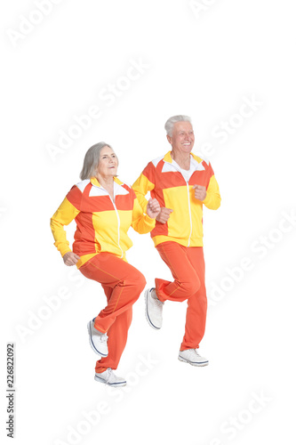 Portrait of active senior couple exercising isolated on white
