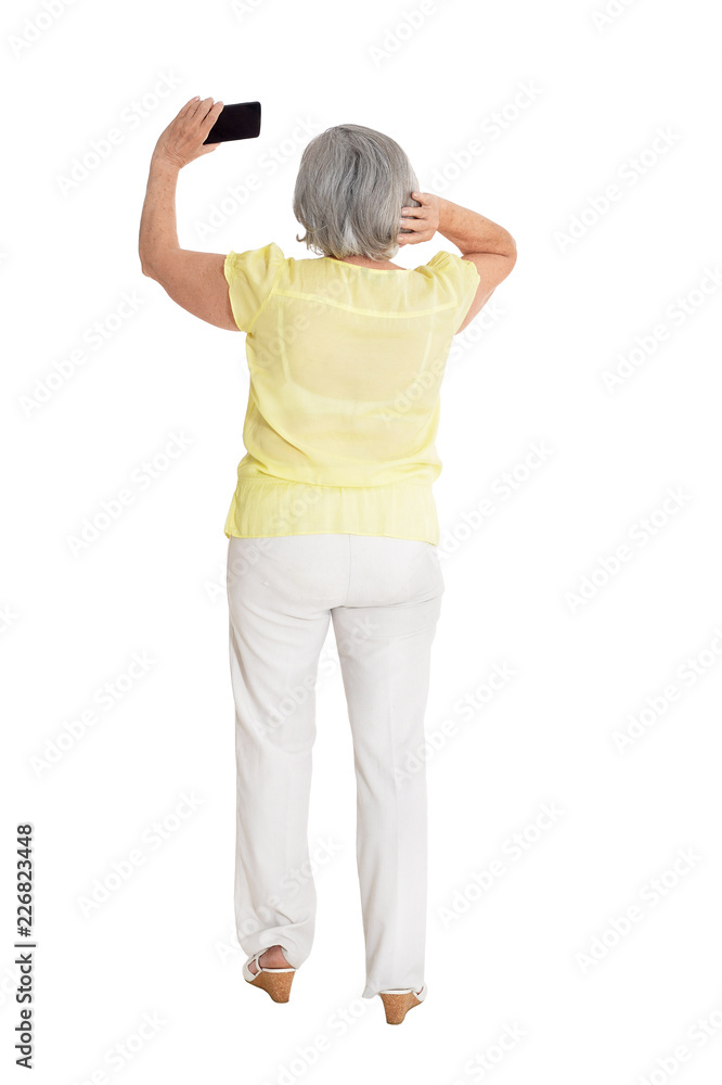 Portrait of senior woman taking selfie on white background Portrait of senior woman taking selfie on white background