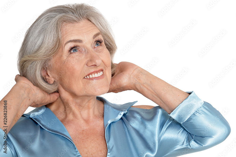 Portrait of beautiful senior woman in light blue blouse posing isolated Portrait of beautiful senior woman in light blue blouse posing isolated