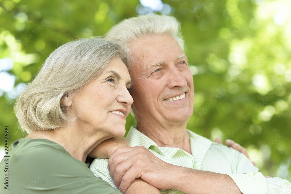 Portrait of happy mature couple smiling and hugging outdoors Portrait of happy mature couple smiling and hugging outdoors