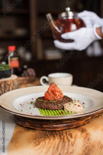 High kitchen: grilled beef meat on msshed green peanut with burdock root puree. Servant pours tea.