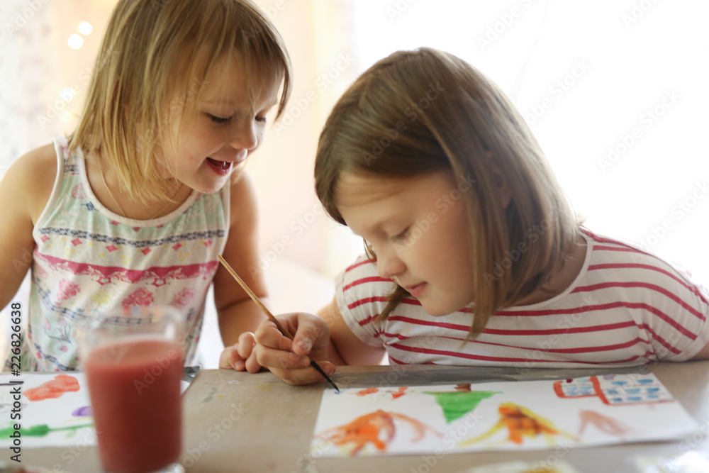 Fototapeta premium Children's creativity. Sisters draws watercolors
