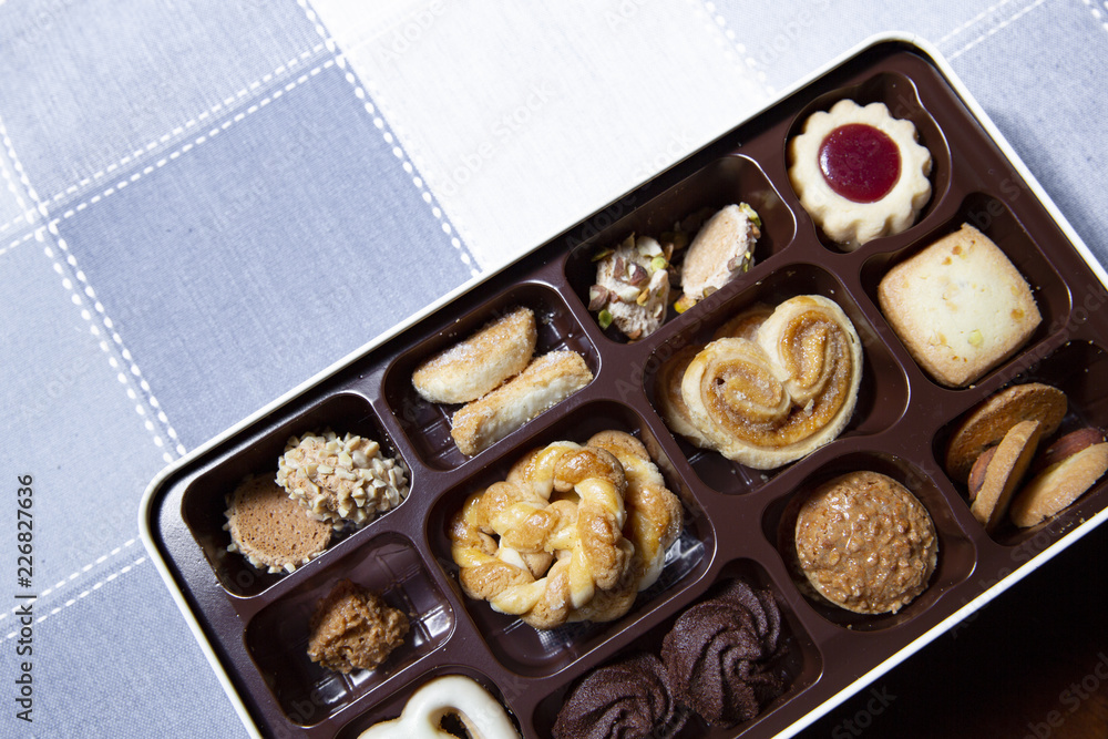 Variety of cookies are placed in the plastic tray, and put on the cloth ( napkin ) with a beautiful pattern. Variety of cookies are placed in the plastic tray, and put on the cloth ( napkin ) with a beautiful pattern.