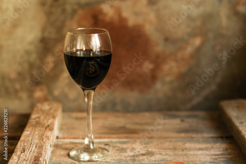 glass of red wine on a wooden table. top view. food background