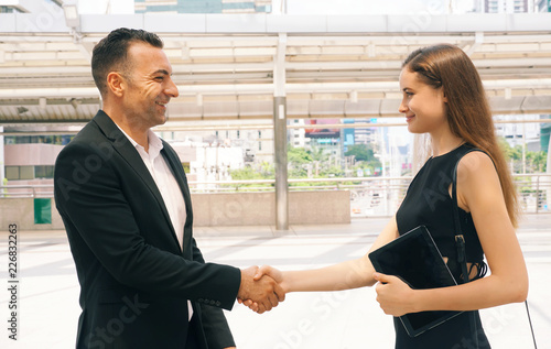Businessman shaking hands with client women after talking business