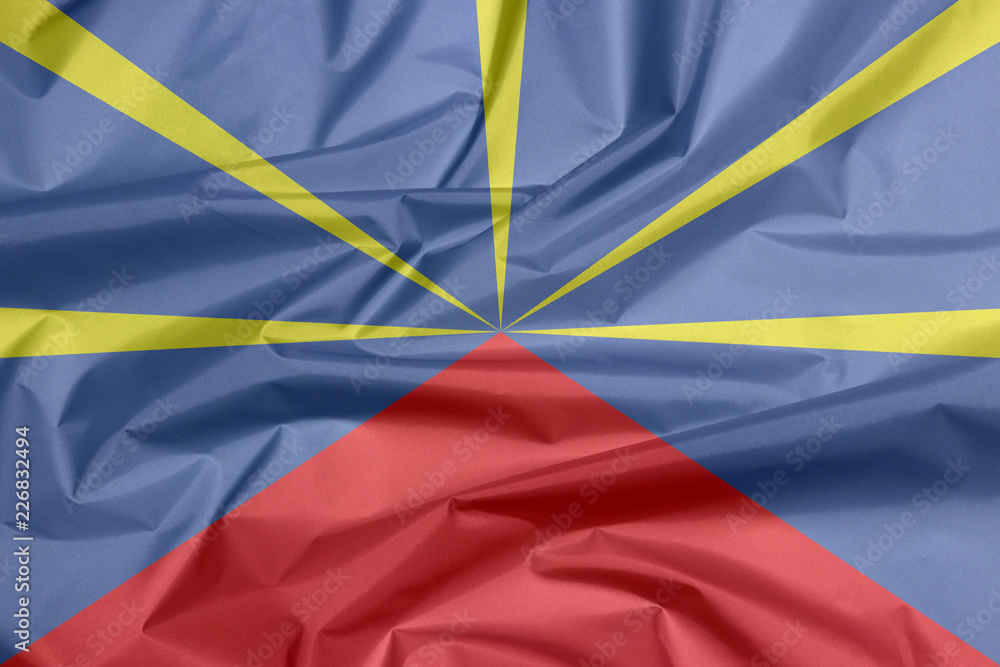 Fototapeta Fabric flag of reunion. Crease of reunion flag background, red yellow and blue color.