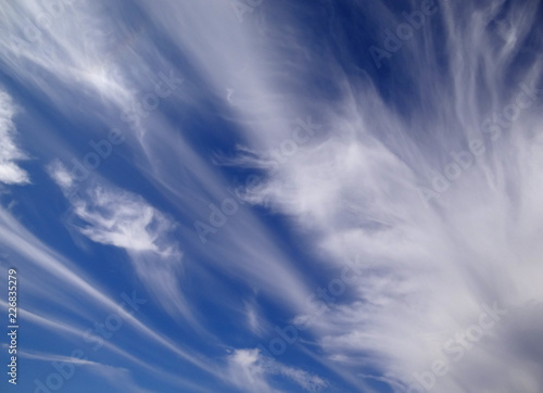 Beautiful strange clouds on blue sky background texture