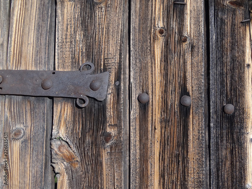Old vintage wooden door with hand-made detail of wrought iron