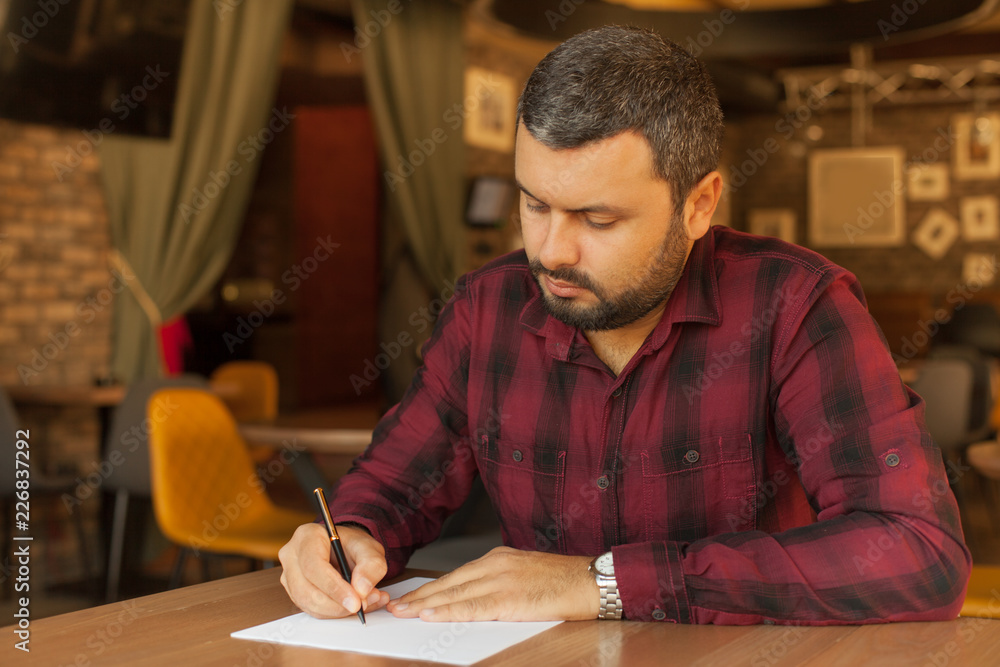 Businessman writing a document Businessman writing a document