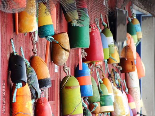 Colored Fishing Net Floats on Red Wall