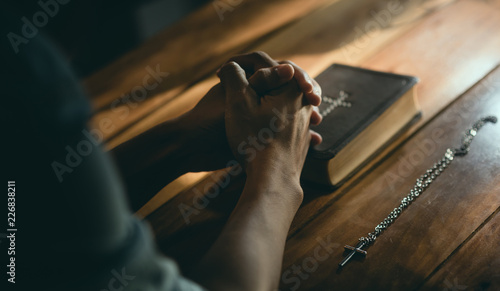 Christians worship praying Bible to the holy scripture. they pray hands in church for the faith and spiritual concept of religion.