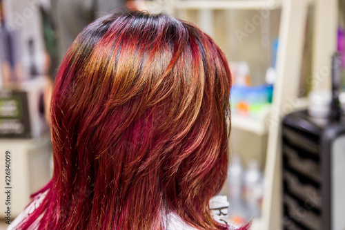 Professional hairdresser dyeing hair. Multicolor with stretching coloring