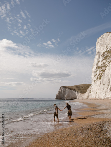 couple on a beach in england by the white cliffs