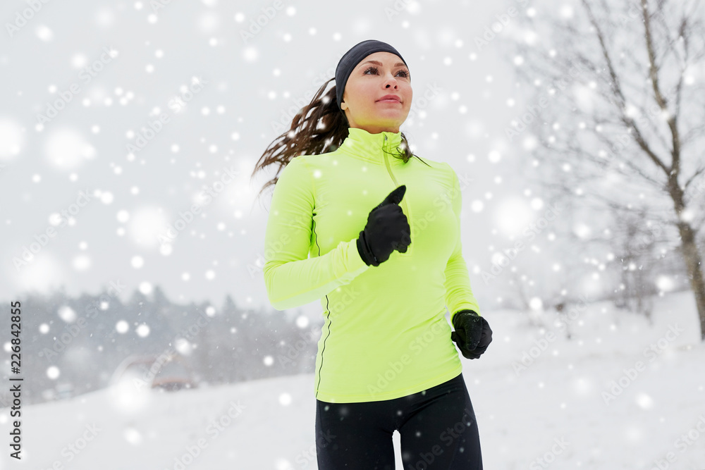 fitness, sport, people and healthy lifestyle concept - happy woman running outdoors in winter fitness, sport, people and healthy lifestyle concept - happy woman running outdoors in winter