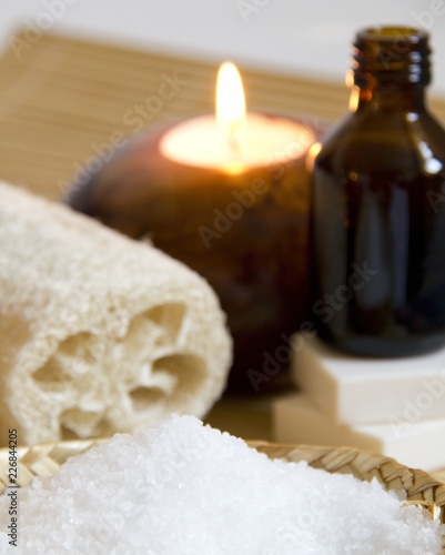 Spa setting with candle, aromatic oil and soap