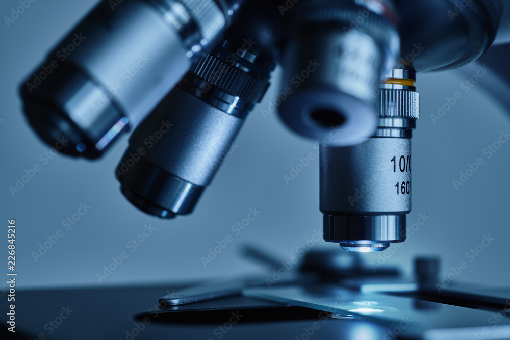 Close-up shot of modern microscope with sample slide at laboratory. Close-up shot of modern microscope with sample slide at laboratory.