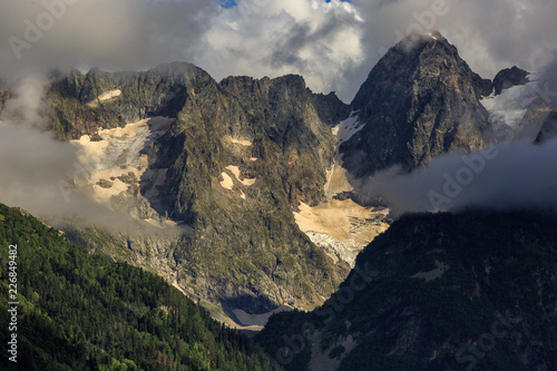 Top of the mountain with glacier, in the clouds. View of the Caucasus Range, Russia.