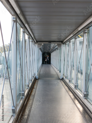 Passengers entering the airport bridge to connect with the plane. © Toniflap