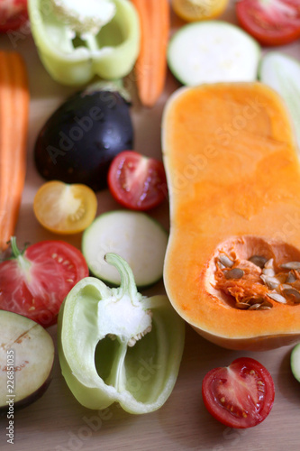 Assortment of various colorful vegetables: butternut squash, zucchini, cucumber, tomato, eggplant, pepper and carrot. Top view, selective focus. 