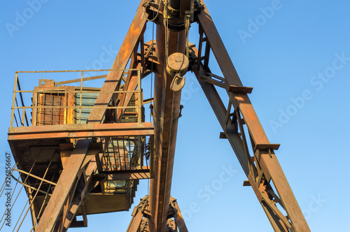 gantry crane, telpher, old, ancient, past, broken, abandoned, rusty, closed production, work; orange; metal; environment; vintage; old; ancient; past; broken; abandoned; rusty; closed production photo